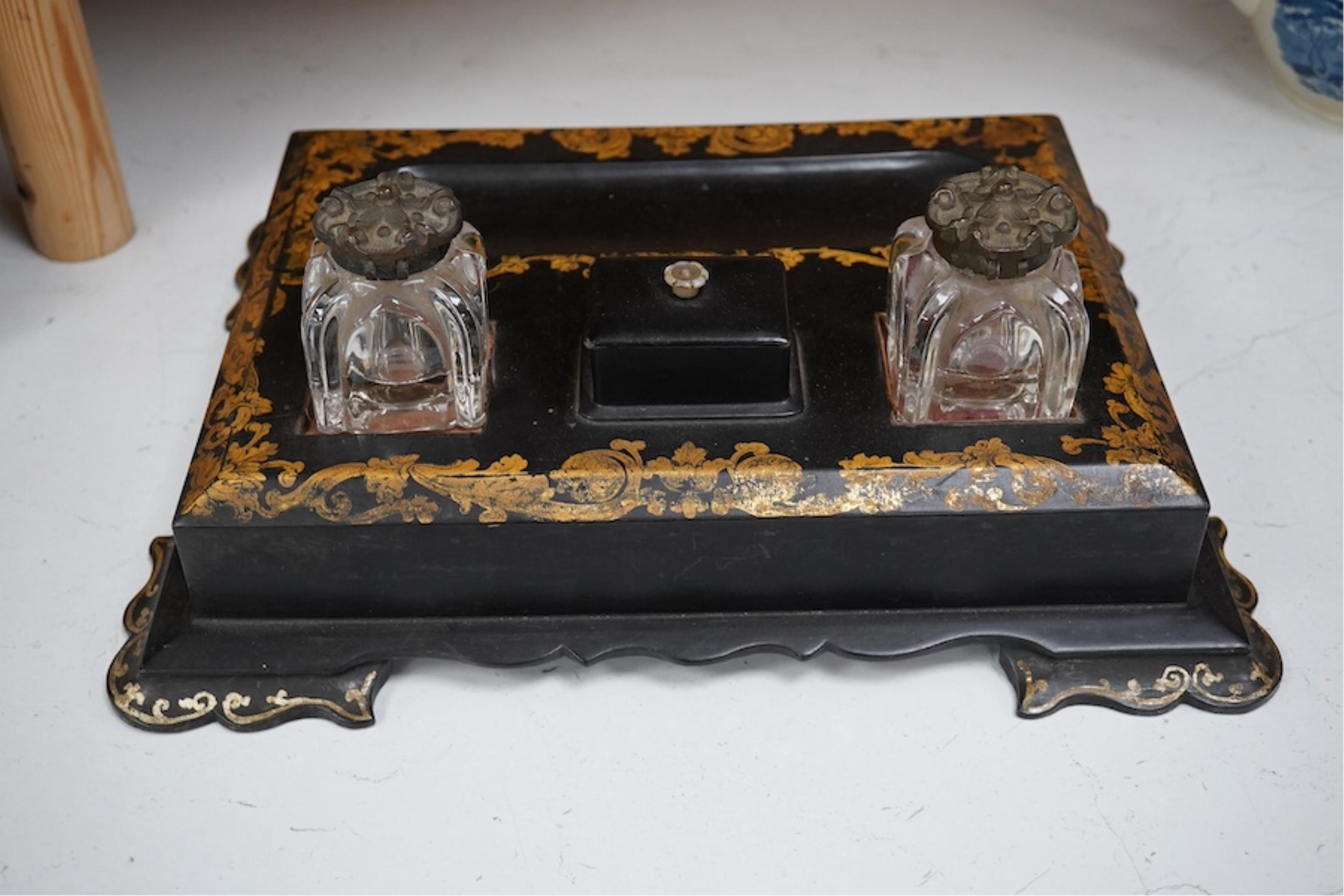 A Victorian black lacquer and gilt decorated two bottle ink stand with drawer. 36cm sided x 28cm deep. Condition - some lacquered missing.